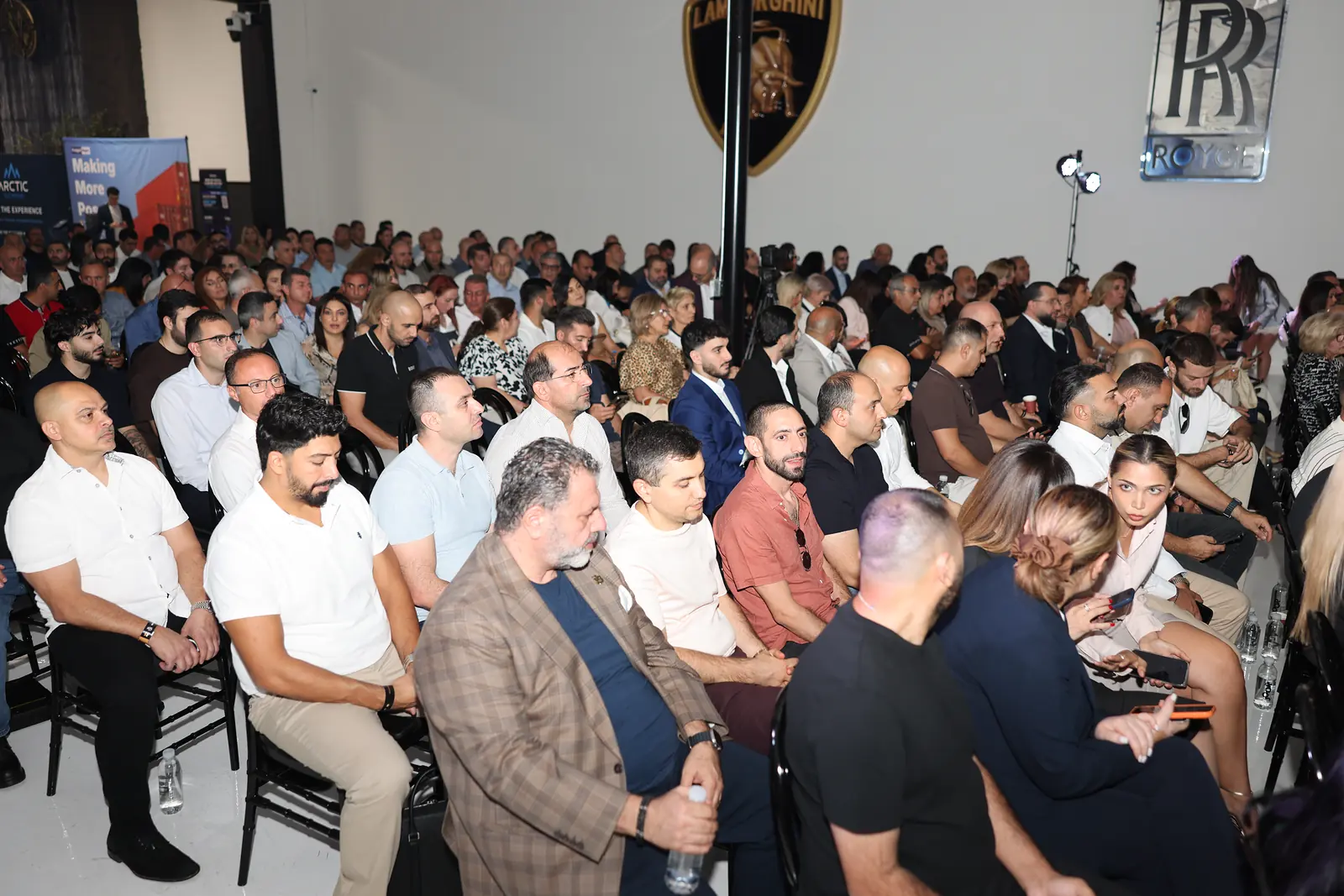 A packed room of guests listening to the talk