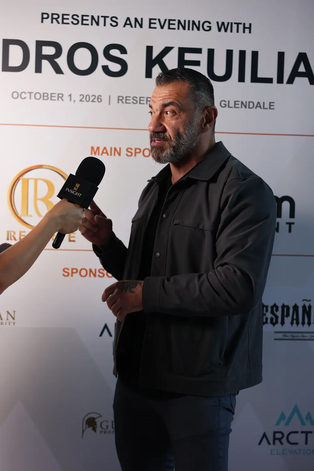 Bedros Keuilian interviewed in front of the step-and-repeat