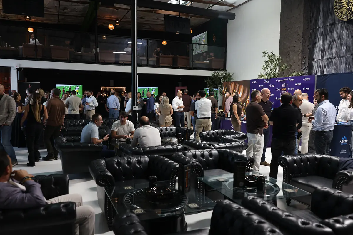Guests filling the lounge and the sponsor tables before the talk
