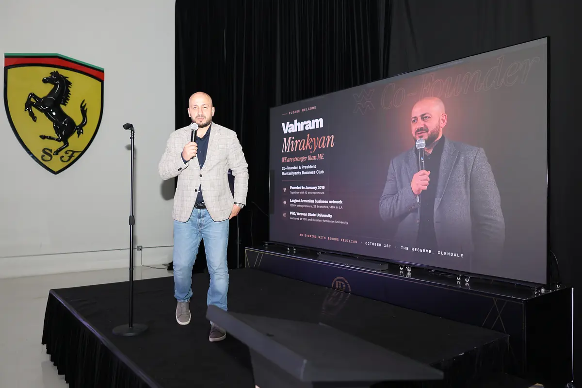 The club co-founder on stage with his walk-on screen