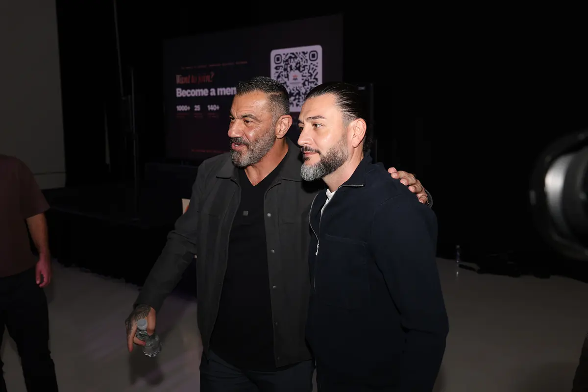 Bedros Keuilian with a guest, the membership QR on the screen behind them